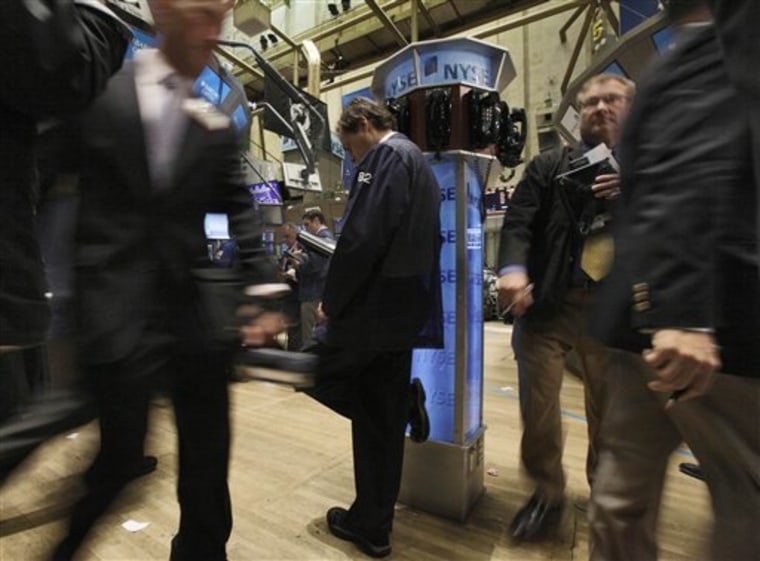 In this June 7, 2010 photo, a trader leans on a phone post as he works on the floor of the New York Stock Exchange, in New York. Stocks are looking for direction Tuesday, June 8, after another late-day plunge sent the Dow Jones industrial average to its lowest level in seven months. Stock futures rose slightly.(AP Photo/Richard Drew)